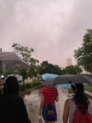 A group walking through the rain in Seoul.